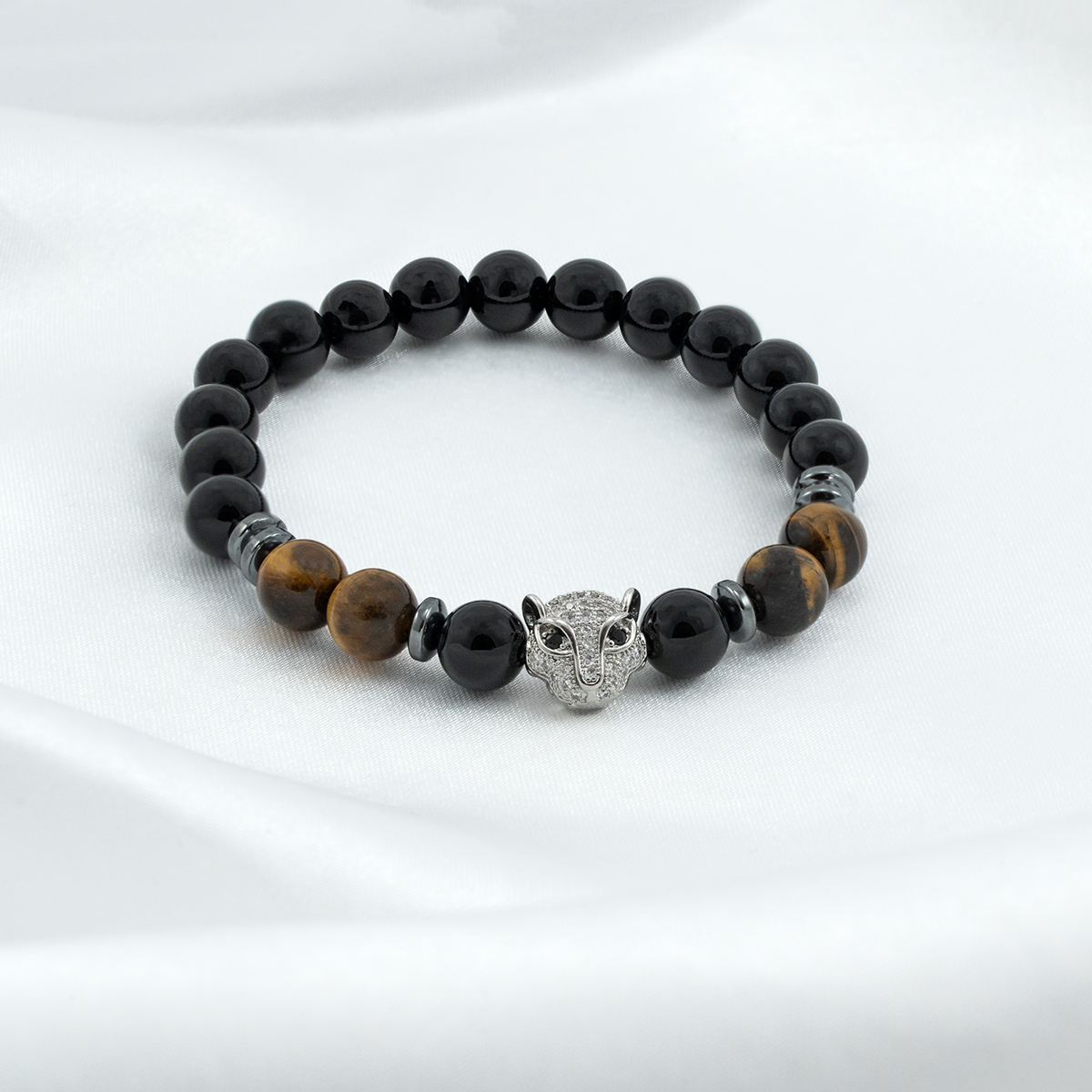 Sisäisen voiman rannekoru, jossa on pantrippi, onyx ja tiikerinsilmä kiviä. 1 Sisäisen voiman rannekoru, jossa on pantrippi, onyx ja tiikerinsilmä kiviä.